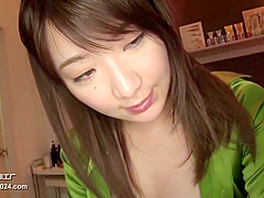 Hot girl wear shinning green silk satin blouse doing massage for guest