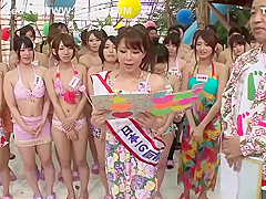 Naughty Japanese babes are kneeling in front of a guy with a hard- on and sucking his cock