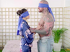 A muscular, tattooed man is fucking a gorgeous Japanese brunette, Katana and cumming all over her