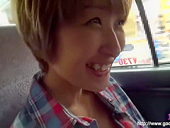 Timid Asian woman enjoys herself in the car