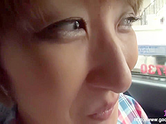 Timid Asian woman enjoys herself in the car