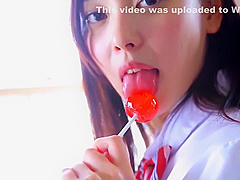 Nishida Natsume sucks a lollipop in school uniform